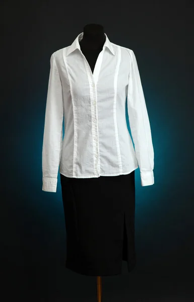 White blouse and black skirt on mannequin on dark color background — Stock Photo, Image