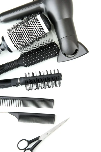 Comb brushes, hairdryer and cutting shears, isolated on white — Stock Photo, Image