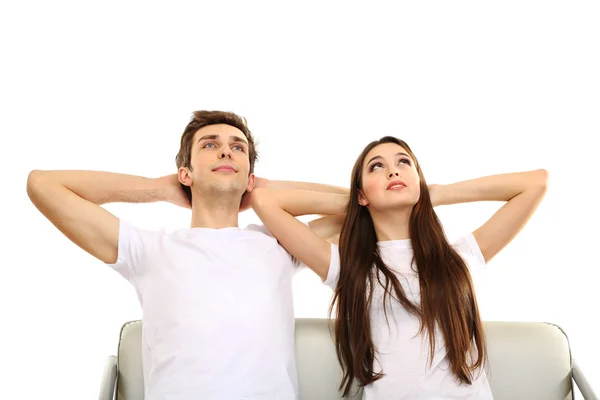 Young couple sitting together isolated on white — Stock Photo, Image