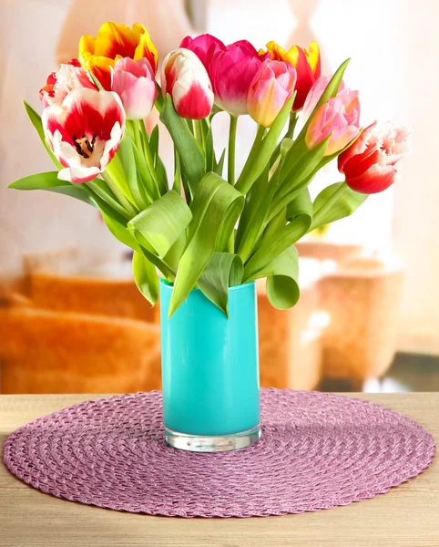 Beautiful tulips in bucket on table in room — Stock Photo, Image