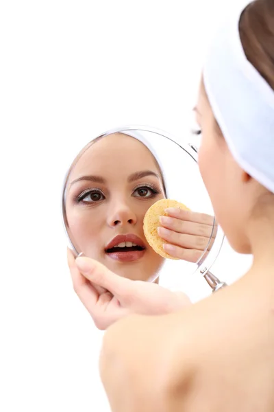 Young woman cleansing her face, isolated on white — Stock Photo, Image