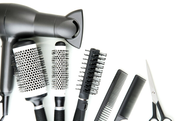 Comb brushes, hairdryer and cutting shears, isolated on white