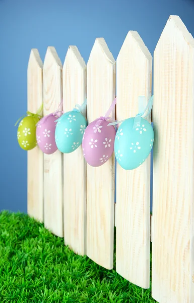 Art Easter background with eggs hanging on fence — Stock Photo, Image
