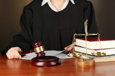 Judge sitting at table during court hearings on black background clipart