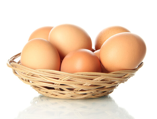 Many eggs in basket isolated on white