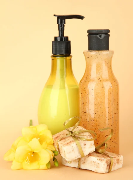 Liquid and hand-made soaps on beige background — Stock Photo, Image