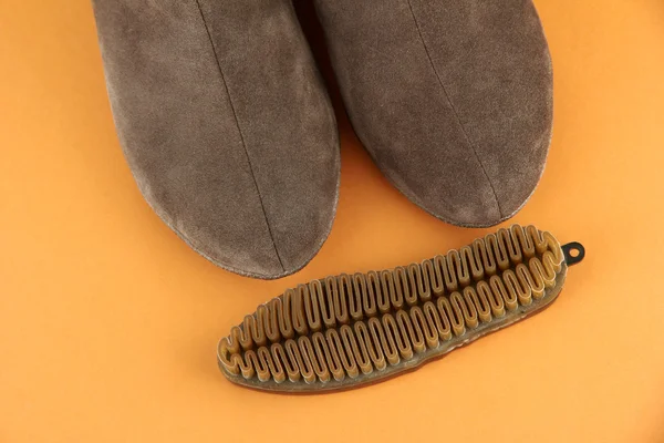 Brush for suede shoes, on color background — Stock Photo, Image