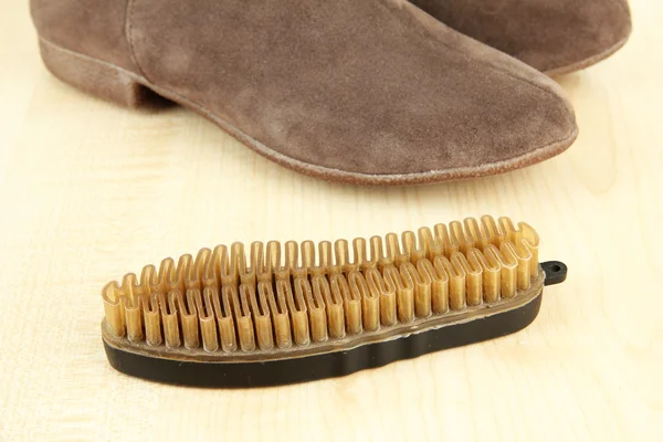 Brush for suede shoes, on wooden background — Stock Photo, Image