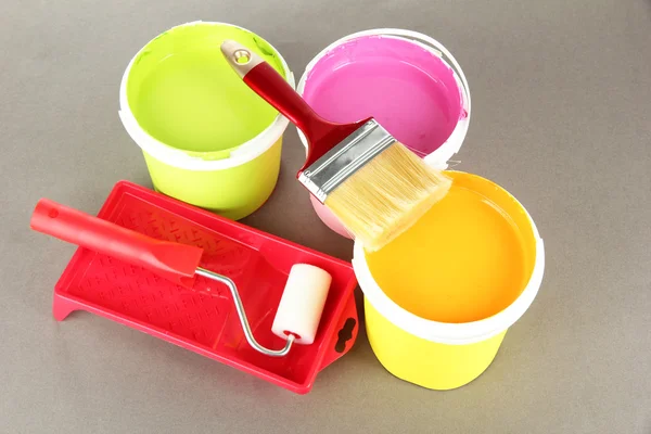 Set for painting: paint pot, brushes, paint-roller on grey background — Stock Photo, Image