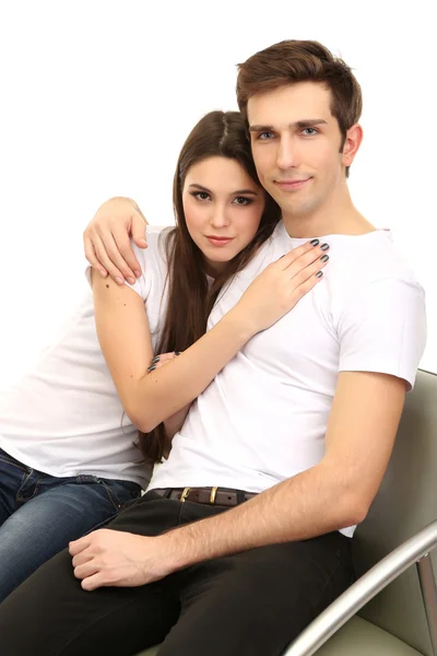 Jovem casal sentado juntos isolado no branco — Fotografia de Stock