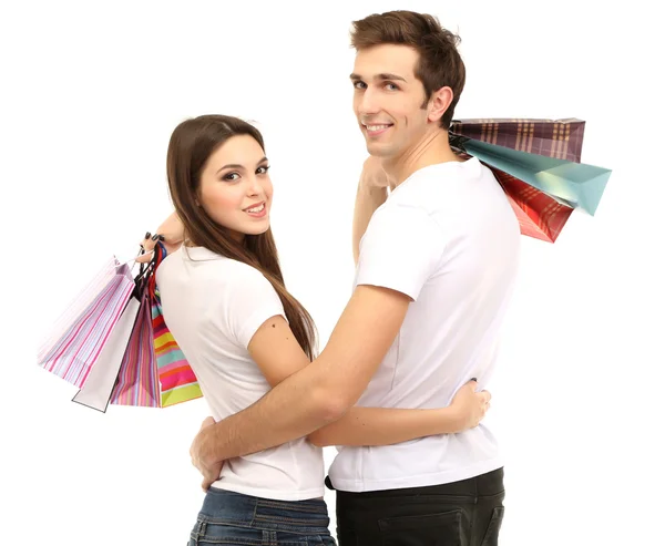 Jeune couple faisant du shopping et tenant de nombreux sacs isolés sur blanc — Photo