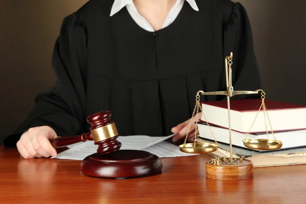 Judge sitting at table during court hearings on black background Stock Image