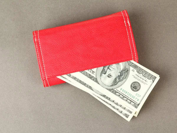 Purse with hundred dollar banknotes, on color background — Stock Photo, Image