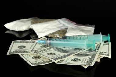 Drugs, money and syringes, isolated on black clipart