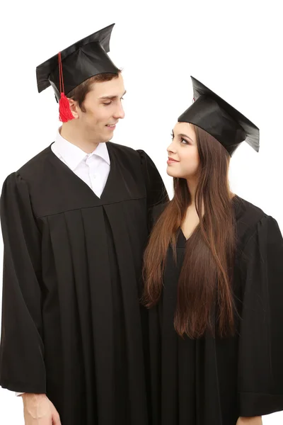 Due felici studenti laureati isolati su bianco — Foto Stock