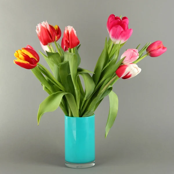 Beautiful tulips in bucket on grey background — Stock Photo, Image