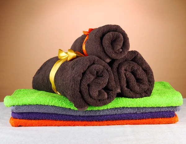 Colorful towels, on brown background — Zdjęcie stockowe