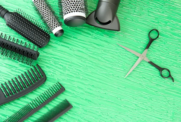 Comb brushes, hairdryer and cutting shears,on color background — Stock Photo, Image