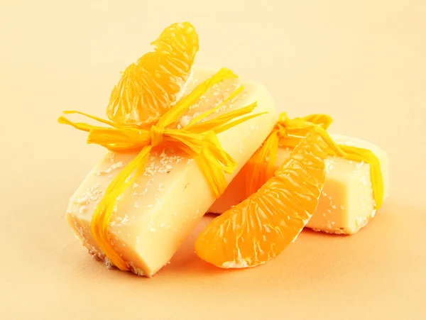 Natural handmade soap and orange, on beige background — Stock Photo, Image