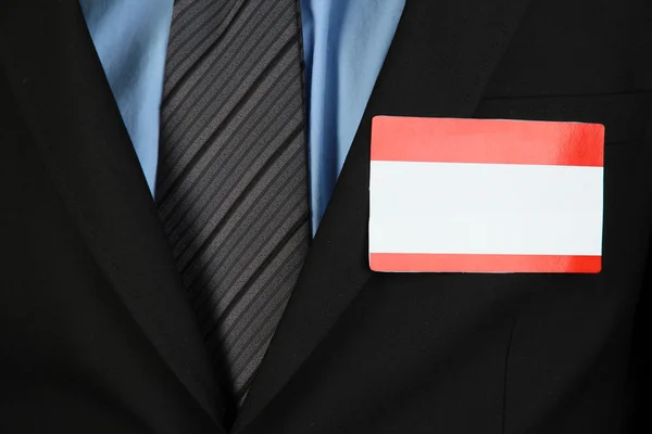 Blank nametag on businessman's black suit close up — Stock Photo, Image