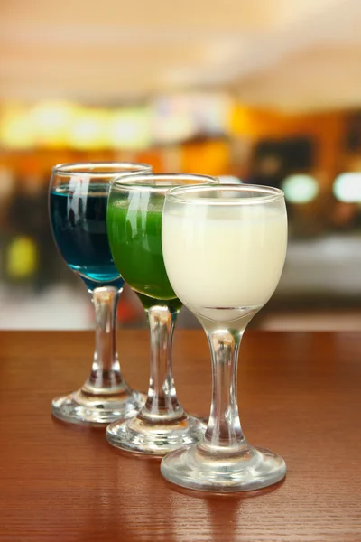 Tasty color liquors, on bright background — Stock Photo, Image