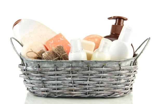 Composition of cosmetic bottles and soap in basket, isolated on white — Stock Photo, Image