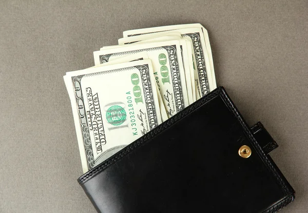 Wallet with hundred dollar banknotes, on color background — Stock Photo, Image