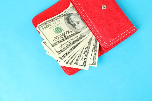 Purse with hundred dollar banknotes, on color background — Stock Photo, Image