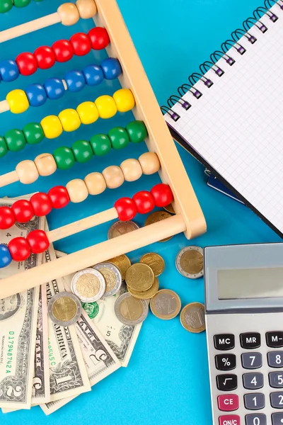 Bright wooden abacus and calculator. Conceptual photo of old and modern business — Stock Photo, Image