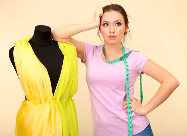 Beautiful young dressmaker in workroom — Stock Photo, Image