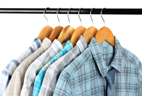 Shirts with ties on wooden hangers on light background — Stock Photo, Image