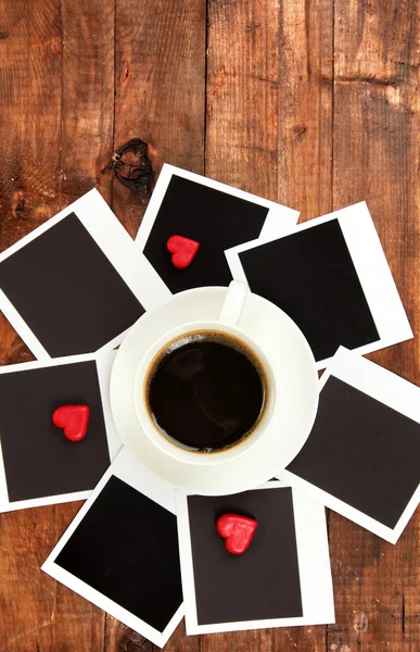 Xícara de café na mesa de trabalho coberto com molduras de fotos de perto — Fotografia de Stock