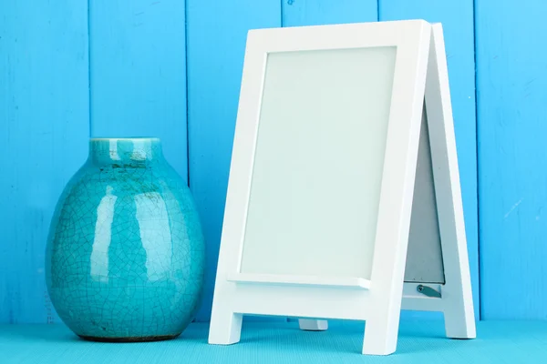 White photo frame for home decoration on blue background