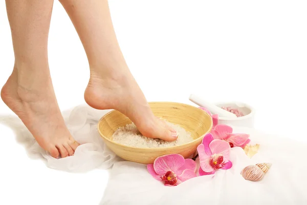 Female feet in spa bowl with sea salt, isolated on white — Stock Photo, Image