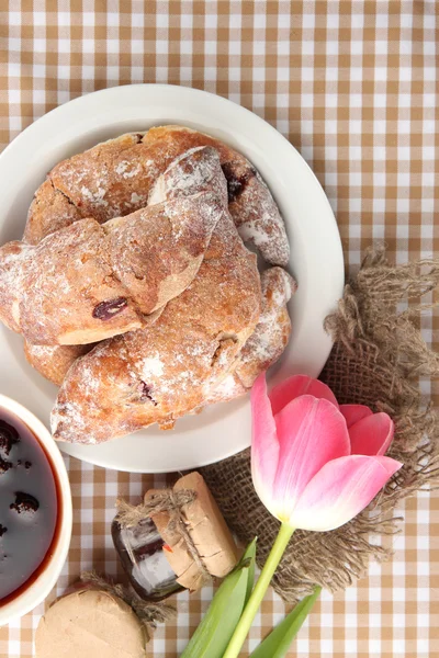 Taste croissants on plate and jam on tableclot — Stock Photo, Image