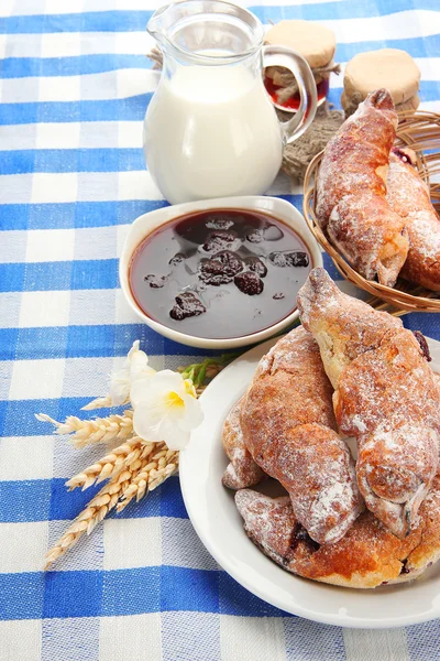 Taste croissants, milk and jam, on tableclot — Stock Photo, Image