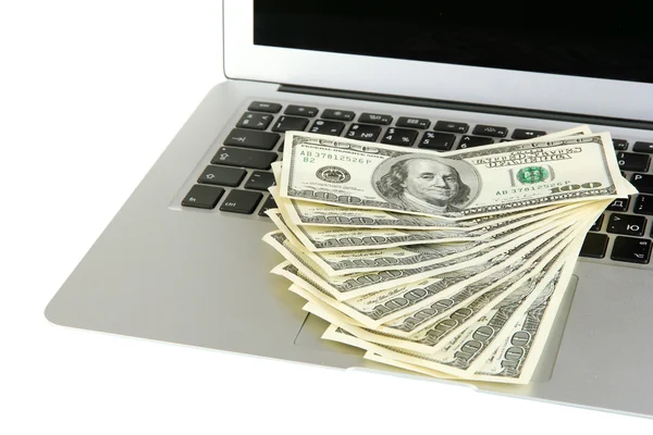 Geld op laptop geïsoleerd op wit — Stockfoto