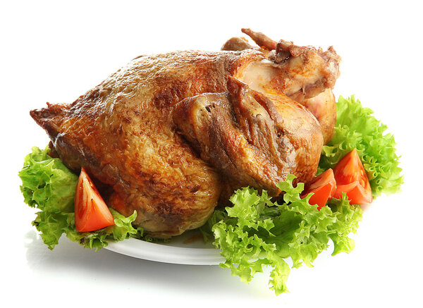 Tasty whole roasted chicken on plate with vegetables, isolated on white