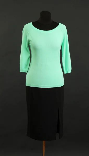 Turquoise blouse and black skirt on mannequin on black background — Stock Photo, Image