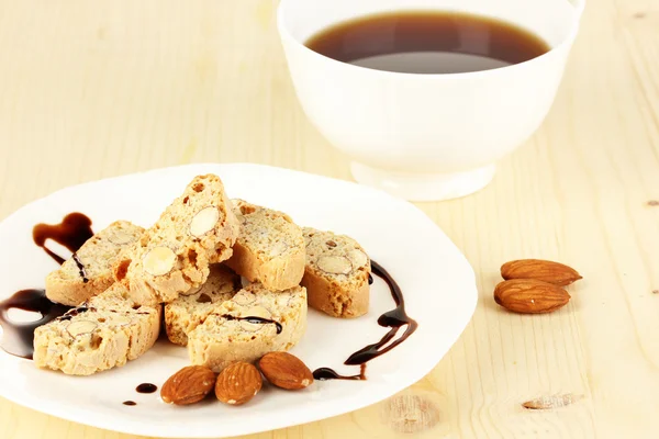 Aromatic cookies cantuccini and cup of coffee on wooden table close-up — Stock Photo, Image