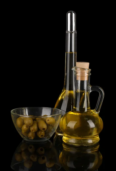 Different types of oil with olives on dark background — Stock Photo, Image