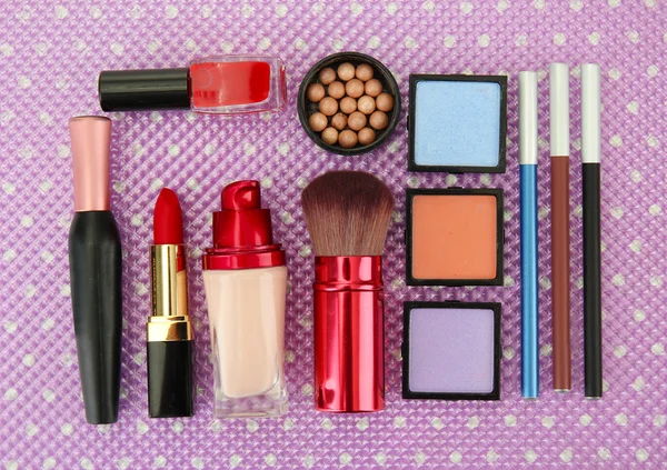 Decorative cosmetics on purple background — Stock Photo, Image