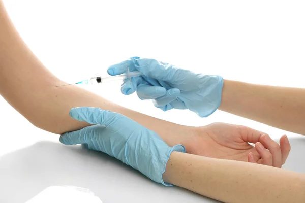 Doctor holding syringe with a vaccine in the patient hand, isolated on white — Stock Photo, Image