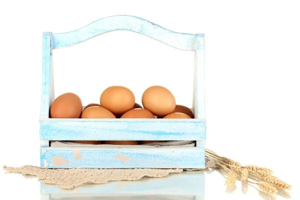 Eggs in blue wooden basket isolated on white — Stock Photo, Image