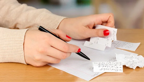 Write off exam on wooden table on room background — Stock Photo, Image