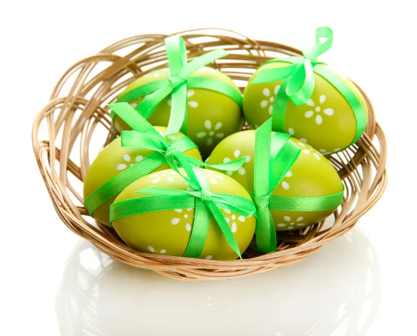 Bright easter eggs with bows in basket, isolated on white — Stock Photo, Image