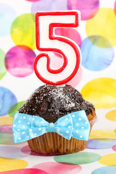 Birthday cupcake with chocolate frosting on bright background — Stock Photo, Image