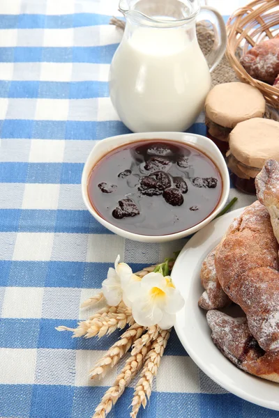 Taste croissants, milk and jam, on tableclot — Stock Photo, Image