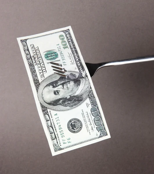 Banknotes on fork on grey background — Stock Photo, Image