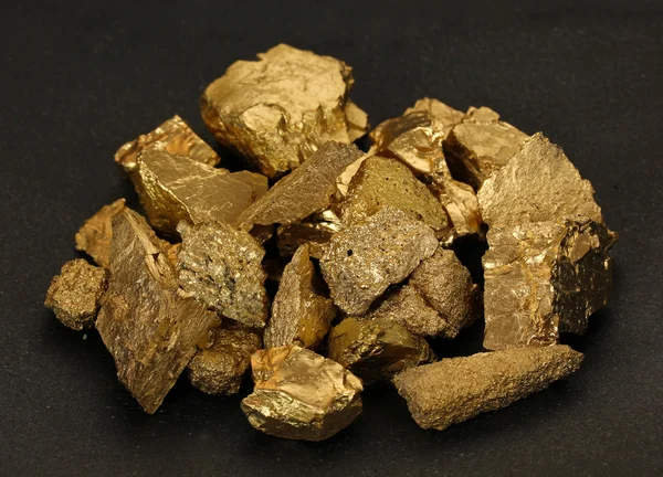 Golden nuggets on black background — Stock Photo, Image